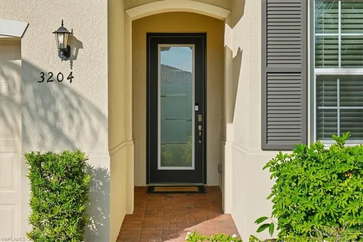 Doorway to property with stucco siding