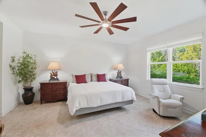 Bedroom with ceiling fan and baseboards