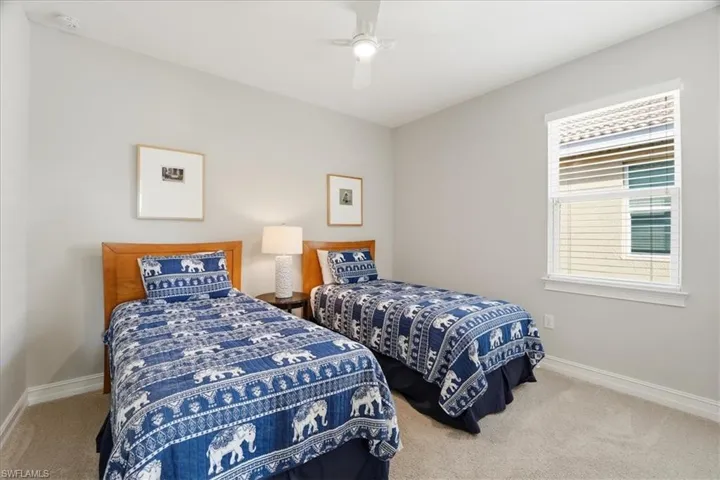 Bedroom featuring light carpet and a ceiling fan