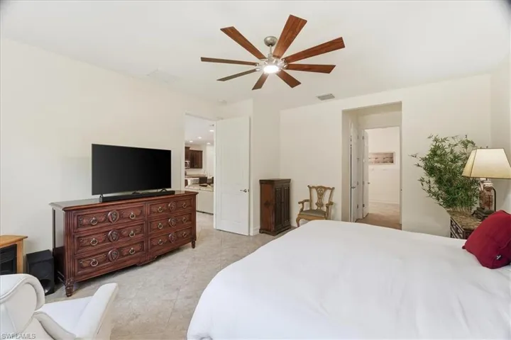 Bedroom with ceiling fan and light tile patterned floors