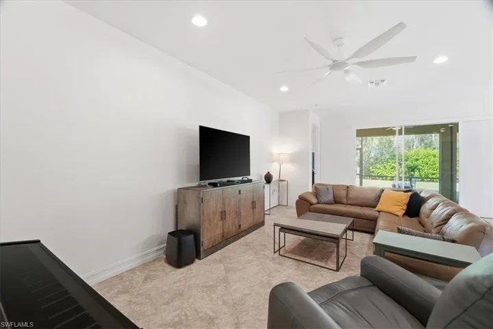 Living room with ceiling fan and recessed lighting