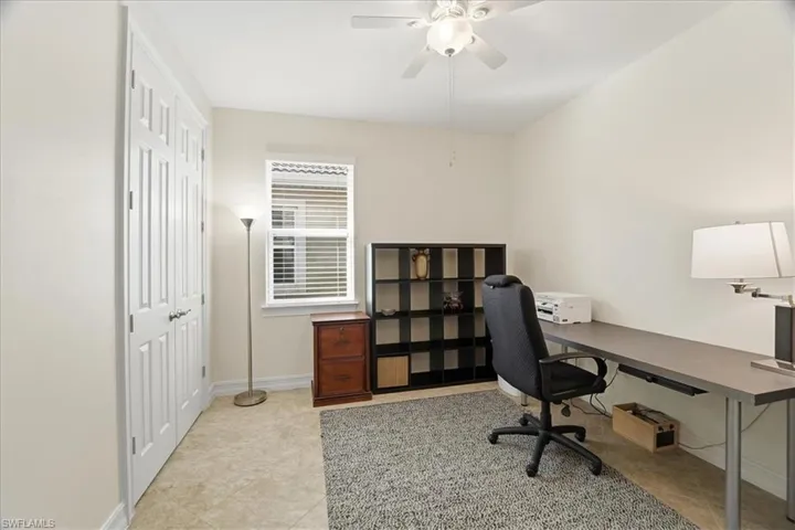 Office area featuring baseboards and a ceiling fan