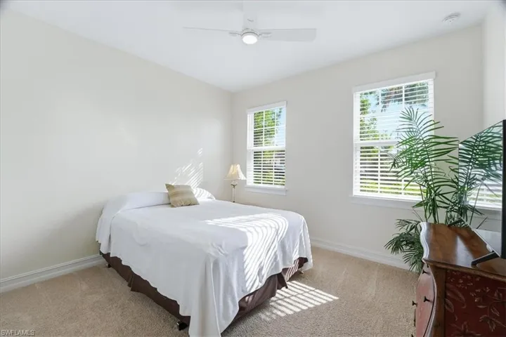 Bedroom featuring light carpet and ceiling fan