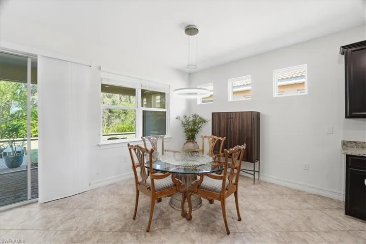 Dining space featuring baseboards and light tile patterned floors