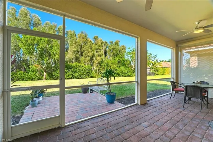Sunroom / solarium with ceiling fan and outdoor dining area