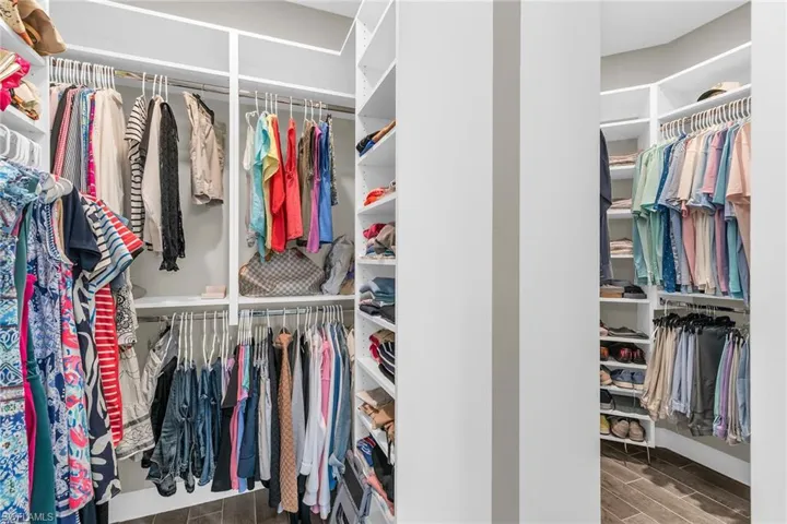 Walk in closet featuring wood finish floors