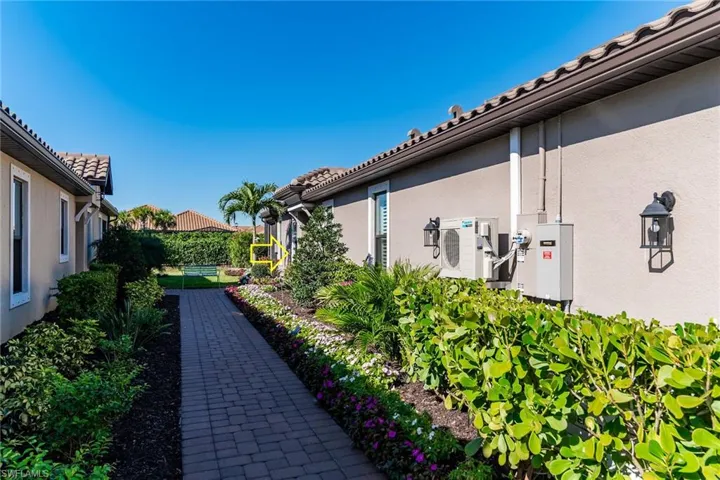 View of home's exterior with a tile roof, fence, and stucco siding