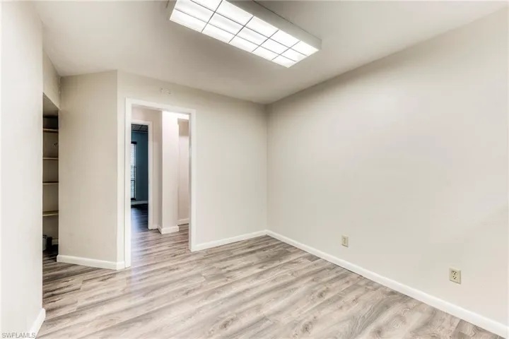 Empty room with light wood finished floors and baseboards