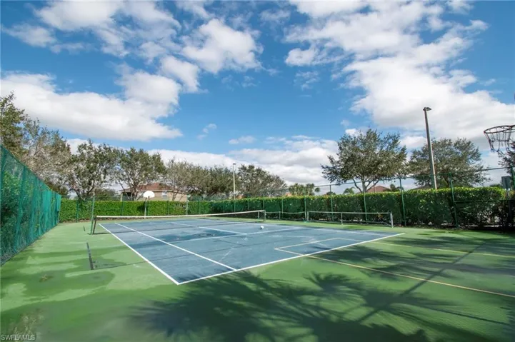 View of tennis court with community basketball court