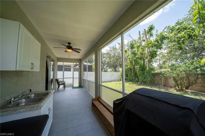 Sunroom featuring a sink and a ceiling fan