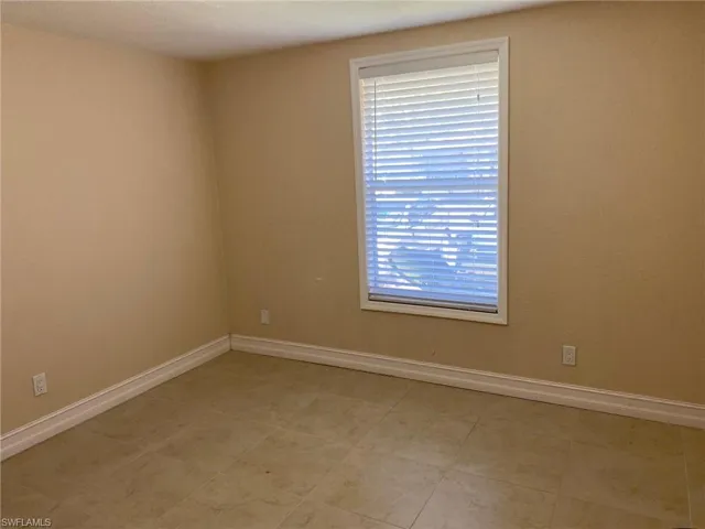 Spare room featuring baseboards