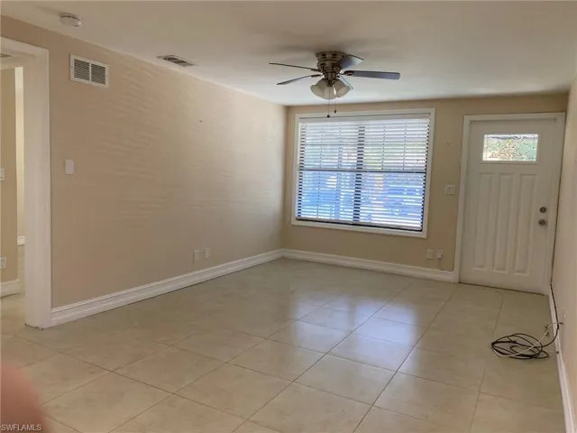 Entrance foyer featuring ceiling fan and light tile patterned flooring