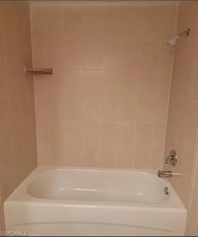 Full bath featuring shower / bath combination