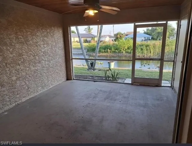 Unfurnished sunroom with a water view