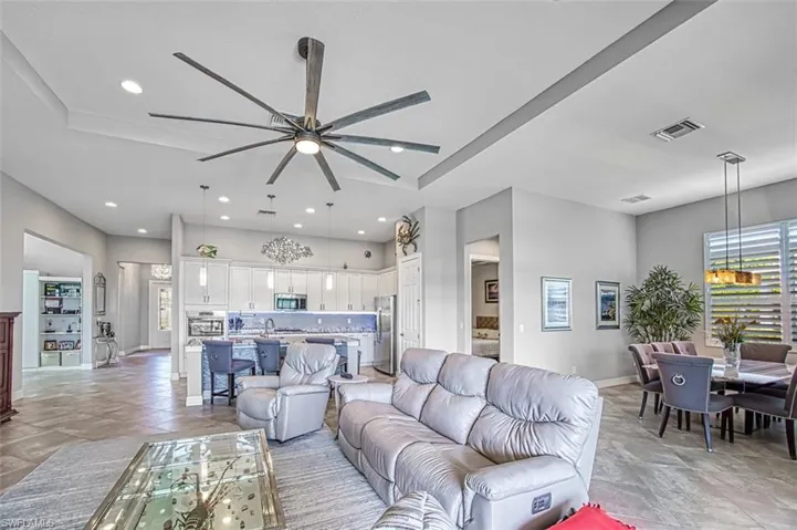 Living room featuring ceiling fan and light tile patterned flooring