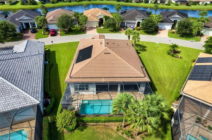 Birds eye view of property with a water view