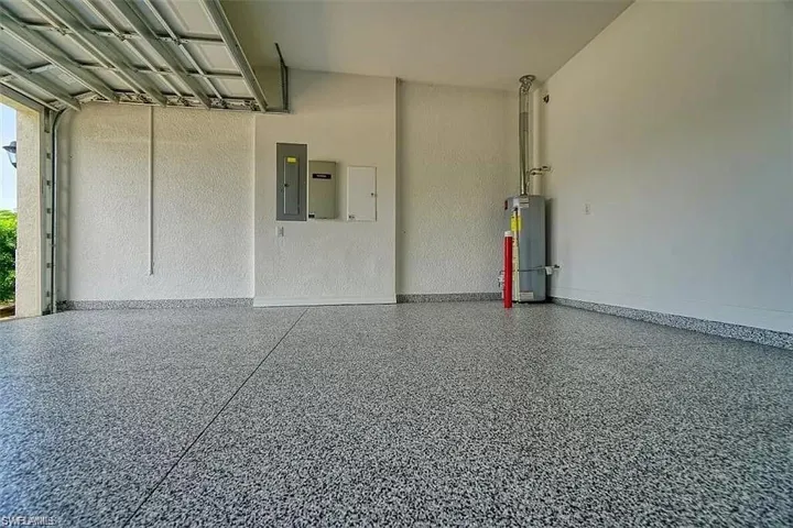 Garage with gas water heater and electric panel