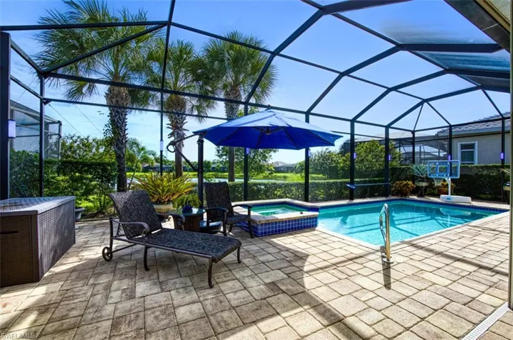 View of pool featuring a lanai, an in ground hot tub, and a patio area
