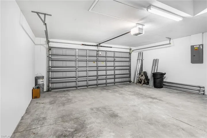 Garage with a garage door opener and electric panel