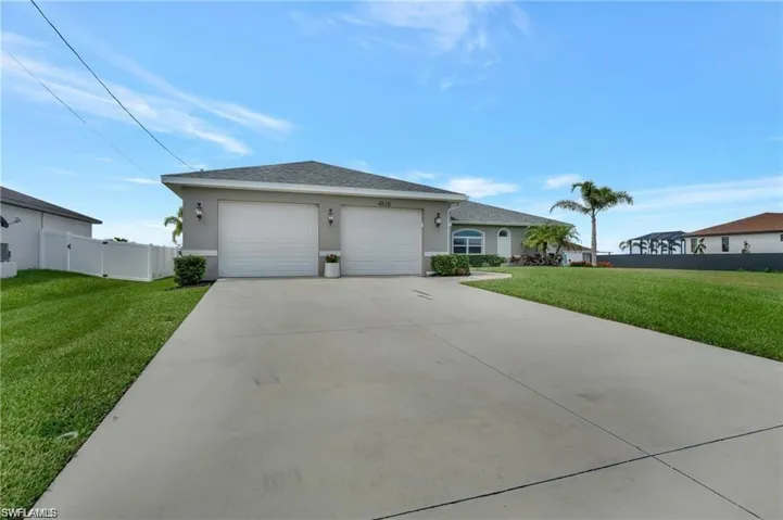 Single story home featuring a garage and a front yard
