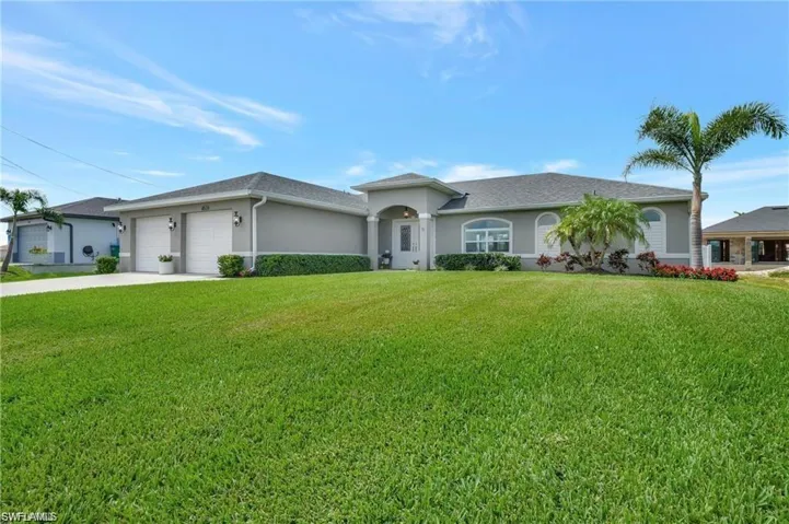 Ranch-style home with a garage and a front yard