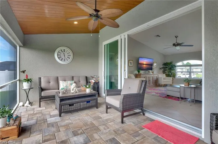 Sunroom with lofted ceiling, wooden ceiling, and ceiling fan