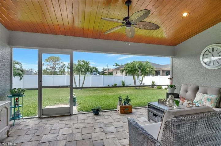 Sunroom with ceiling fan and wood ceiling