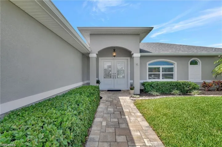 Entrance to property featuring a lawn