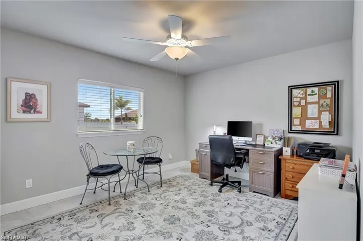 Office space featuring light tile patterned flooring and ceiling fan