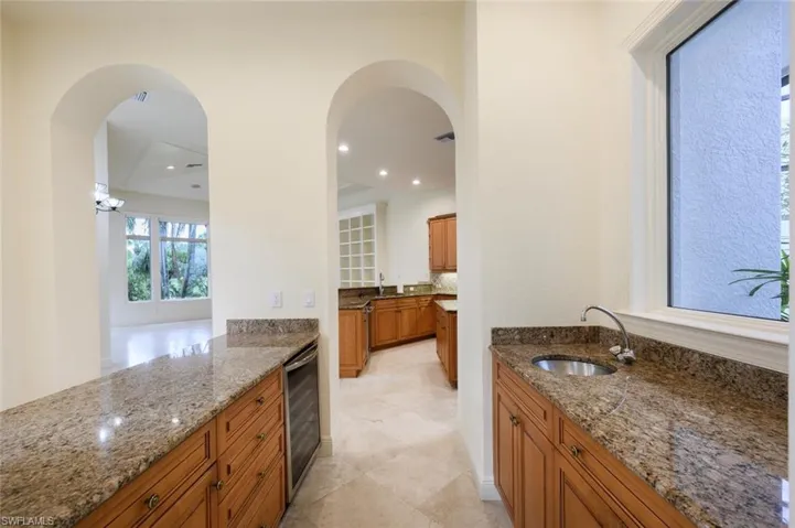 Kitchen with Granite Counter Tops and Picture window with Private Lanai view