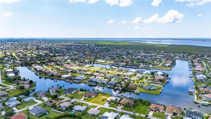 Birds eye view of property with a water view