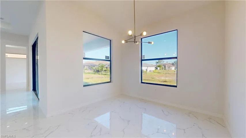 Unfurnished dining area featuring a chandelier and light marble finish floors