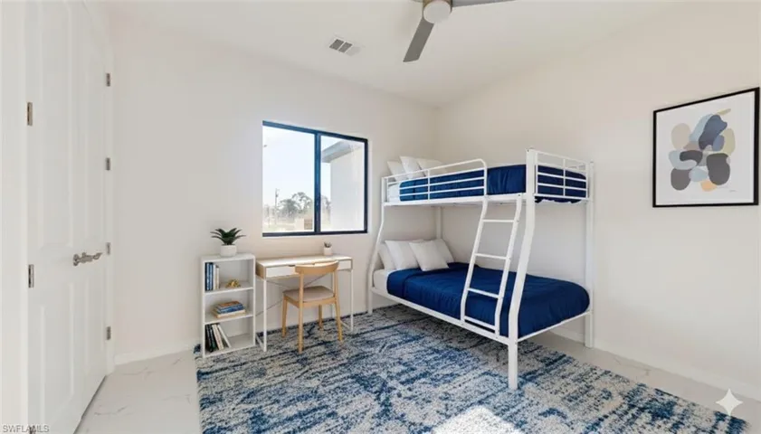 Bedroom featuring marble finish floors and a ceiling fan