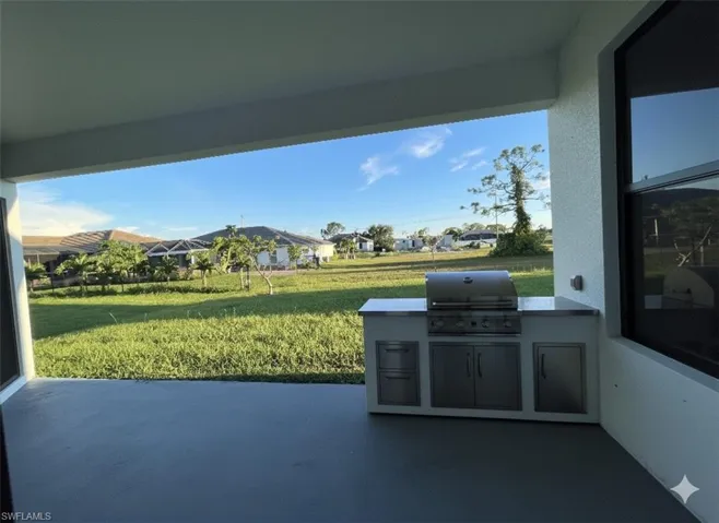 View of patio featuring an outdoor kitchen and a residential view