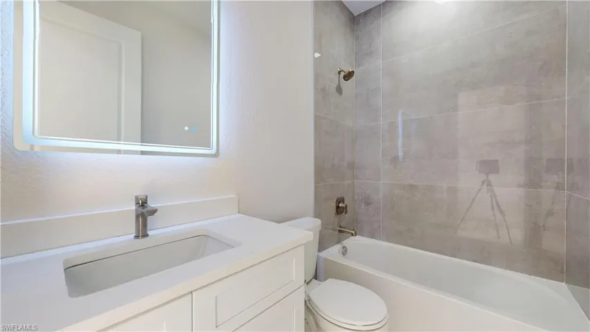 Full bathroom with shower / tub combination and vanity