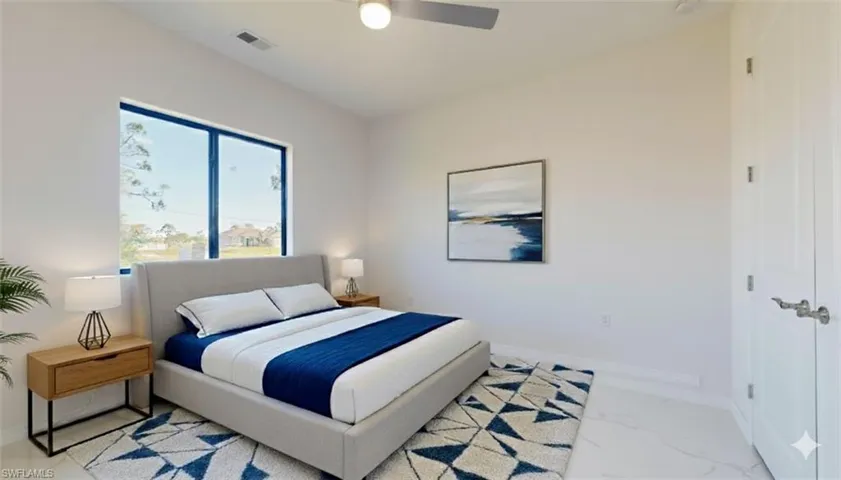 Bedroom featuring ceiling fan and marble finish flooring
