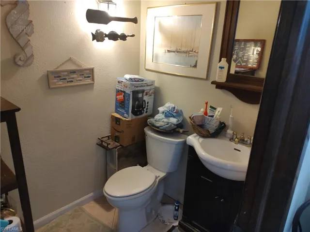 Bathroom featuring vanity, tile patterned flooring, and toilet