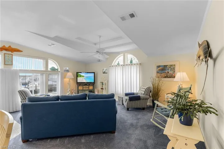 Living Room with higher ceilings and lots of windows with natural light.