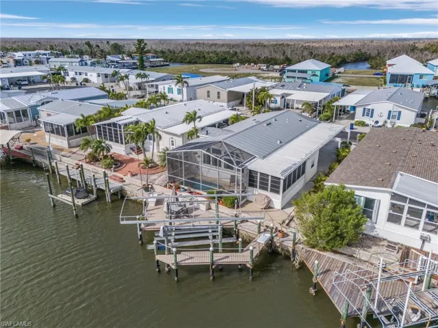 Home with pool overlooking the canal with wrap-around composite decking.