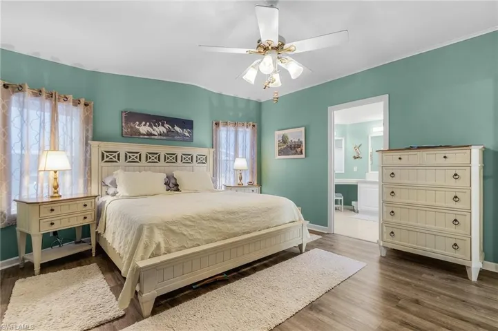 Master bedroom with plank flooring.