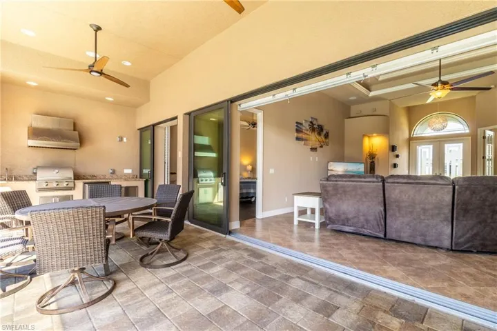 View of patio featuring french doors, area for grilling, and ceiling fan