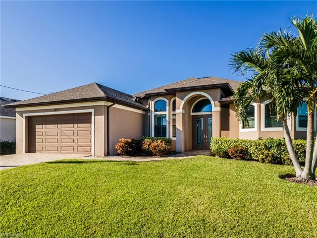 View of front of house featuring a garage and a front yard
