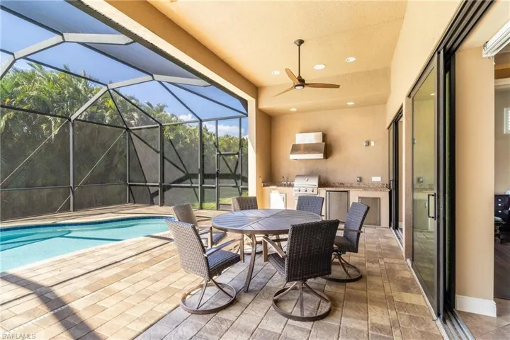 View of patio with a grill, a lanai, and ceiling fan