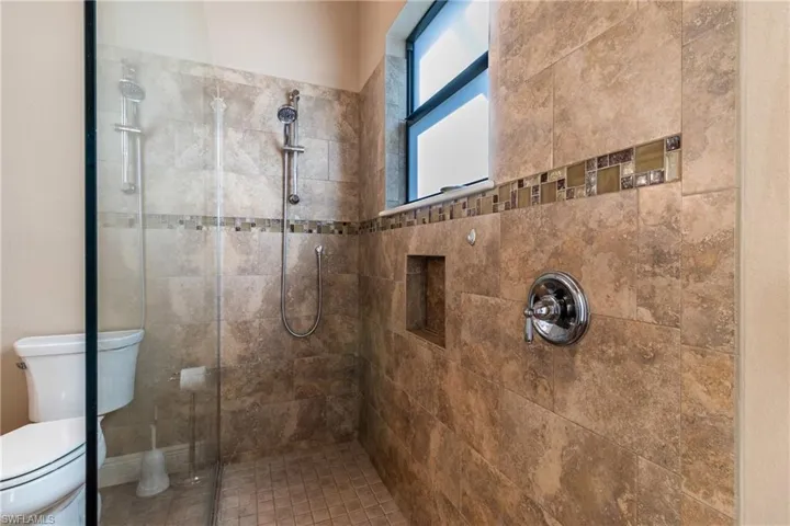 Bathroom featuring toilet and a tile shower
