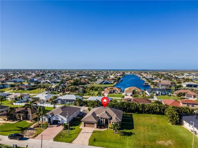 Birds eye view of property with a water view