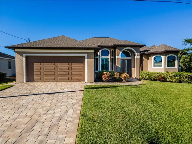 View of front of home featuring a garage and a front yard
