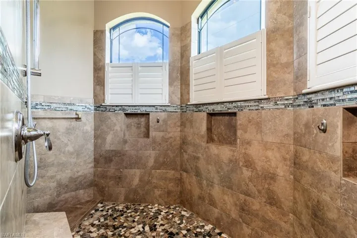 Bathroom with tile walls and a tile shower