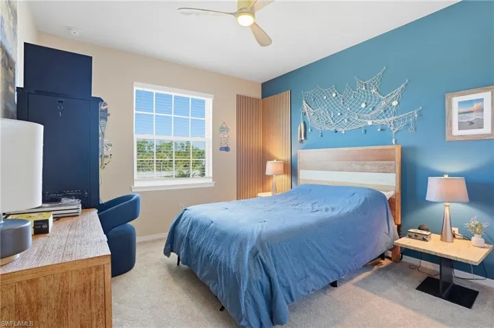 Bedroom with light carpet and ceiling fan