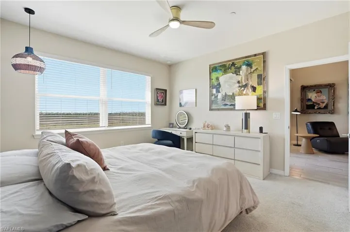 Bedroom featuring light carpet and a ceiling fan