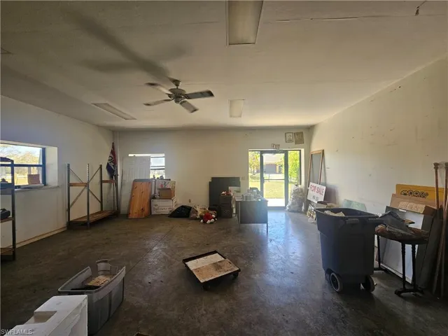 Misc room featuring concrete floors, a ceiling fan, and a healthy amount of sunlight